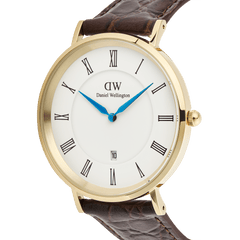Close-up of the Classic Roman Numerals Date Dark Brown Croc Belly Gold watch, showing its gold PVD-plated case, white dial with black Roman numerals, blue hands, date window, and textured dark brown crocodile-embossed leather strap.