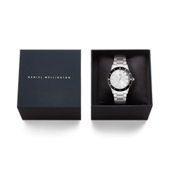 Daniel Wellington Iconic Paradigma Link Black Bezel men's watch presented in a sleek black gift box, highlighting its silver stainless steel bracelet and bold black bezel for an elegant gifting experience.