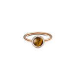 Rose gold ring with a round tiger eye stone at the centre, surrounded by a halo of white cubic zirconia crystals on a slim, polished band.