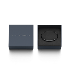 Classic Bracelet in matte black stainless steel displayed in an elegant Daniel Wellington gift box, highlighting its slim cuff design and engraved branding.