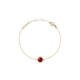Delicate gold bracelet featuring a slim adjustable chain and a central domed red agate stone, surrounded by a halo of sparkling white cubic zirconia crystals.