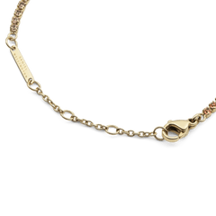 Detail of the Classic Tennis Bracelet Apricot Gold showing the gold lobster clasp, adjustable sizing rings, and individually set apricot-coloured crystals.