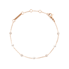 Delicate rose gold bracelet featuring alternating Swarovski glass pearls and cubic zirconia stones on a fine chain, designed with an adjustable clasp for a comfortable fit.