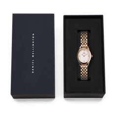 Ophelia Mini Rose Gold ladies watch with a polished rose gold bracelet and white sunray dial, elegantly presented in a black Daniel Wellington gift box.
