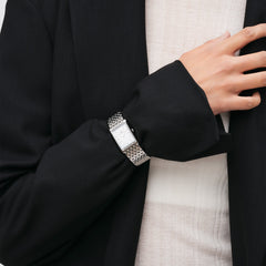 Bound 9-Link Silver ladies watch with a rectangular stainless steel case and integrated silver bracelet, worn with a black blazer and light top for a modern, sophisticated look.