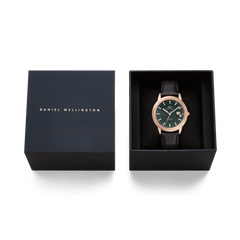 Daniel Wellington Iconic Sheffield Automatic Rose Gold watch with a green enamel dial and black leather strap, presented in an elegant branded gift box.