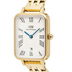 Close-up of the Quadro Roman Numerals Date 5-link Gold ladies watch showing the rectangular white guilloché dial, black Roman numerals, blue hands, date window, and polished gold bracelet.