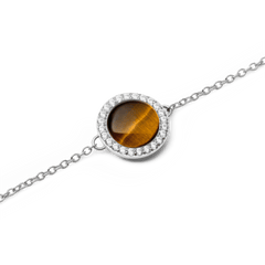 Close-up of the Audrey Bracelet Tiger Eye Silver, showing a polished tiger eye gemstone set in a round silver halo with sparkling white cubic zirconia on a delicate silver chain.