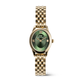 A petite gold women’s watch with an oval case, emerald green sunray dial, gold Roman numerals, and a polished gold beans link bracelet.