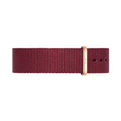 NATO style watch strap in rich ruby red polyester with a rose gold buckle, featuring a slim, minimalist design and adjustable fit.