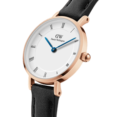 Close-up of the Petite Roman Numerals Sheffield Rose Gold ladies watch, highlighting its rose gold case, white dial with Roman numerals, blue steel hands, and black genuine leather strap.