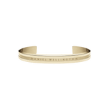 Slim gold cuff bracelet with a minimalist design, featuring engraved Daniel Wellington branding and a polished finish suitable for everyday wear or special occasions.