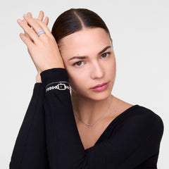 A woman wearing the Quadro Mini Arch 3-link Onyx Sunray Silver watch on her wrist, styled with silver jewellery and a black top, showcasing the petite rectangular case and slim three-link bracelet in a modern, elegant look.