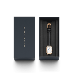 Quadro Roman Numerals Sheffield Rose Gold ladies watch presented in a sleek Daniel Wellington gift box, featuring a rectangular rose gold case, white dial with Roman numerals, and a slim black leather strap.