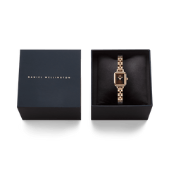 Quadro Mini Arch 3-link Amber Sunray Rose Gold ladies watch presented in a sleek Daniel Wellington gift box, featuring a rectangular brown sunray dial and polished rose gold 3-link bracelet, ideal for gifting or special occasions.