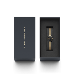 Quadro Mini Evergold Onyx gold watch with a rectangular black dial and gold mesh strap, presented in a sleek Daniel Wellington gift box for a refined gifting experience.