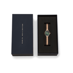 Petite Mini Emerald Melrose watch with a rose gold mesh strap and emerald green dial, presented in a sleek Daniel Wellington gift box.