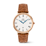 Classic men’s watch with a rose gold case, crisp white dial featuring black Roman numerals, blue hands, a date window at six o’clock, and a light brown croc-embossed leather strap.