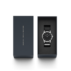 Daniel Wellington Iconic Black NATO Black Dial watch presented in a sleek branded gift box, showcasing its minimalist black dial, polished silver case, and textured black NATO strap.