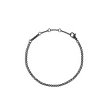 Black Crystal Tennis Bracelet featuring a sleek black stainless steel chain with claw-set Preciosa black crystals and adjustable sizing rings for a comfortable fit.
