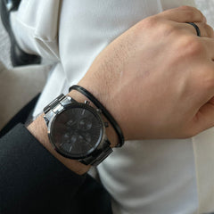 Classic Bracelet in matte black worn alongside a matching black watch, showing its slim cuff design and understated style suitable for everyday and formal wear.