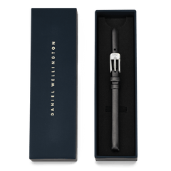 Pressed Sheffield Strap Silver presented in a premium navy blue Daniel Wellington box, featuring a slim black leather strap with a polished silver buckle, ideal as a stylish gift or replacement for small watches.