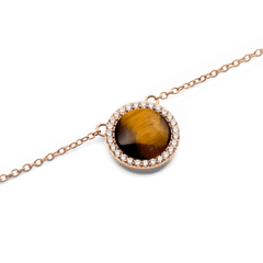 Close-up of the Audrey Necklace Tiger Eye Rose Gold pendant, featuring a domed tiger eye stone surrounded by a halo of white cubic zirconia crystals on a fine rose gold chain.