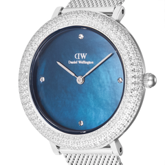 Close-up of the Daniel Wellington Crystalline Bezel Sterling Blue ladies watch showing the blue mother of pearl dial, crystal hour markers, and a double row of sparkling stones on the bezel.