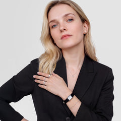 A woman wearing the Daniel Wellington Bound Mini Black Lizard Silver watch styled with a black blazer, showing the slim rectangular silver case and black lizard grain leather strap for a refined, modern look.