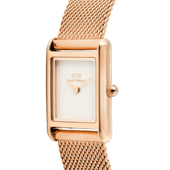 Close-up of the Bound Mini Melrose rose gold watch showing its rectangular case, minimalist white dial, and finely woven mesh strap with a polished finish.
