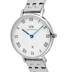 Close-up of the Petite Roman Numerals Date 5-link Silver watch, highlighting the polished stainless steel bracelet, white guilloché dial with Roman numerals, blue hands, and date window at 6 o’clock.