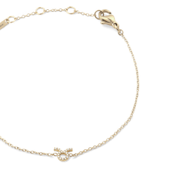 Close-up of the Crystal Zodiac Chain Bracelet Gold with a fine gold chain, adjustable sizing rings, and a crystal-encrusted Taurus zodiac charm at the centre.