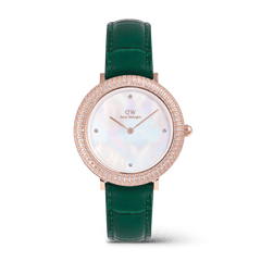 Rose gold ladies watch with a green crocodile-embossed leather strap, a crystal-set bezel, and a white mother of pearl dial with minimalist crystal markers.