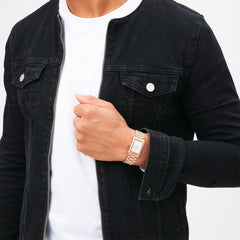 Bound 3-Link Rose Gold watch with a rectangular case and rose gold bracelet, worn with a white shirt and black denim jacket for a stylish, modern look suitable for everyday wear.