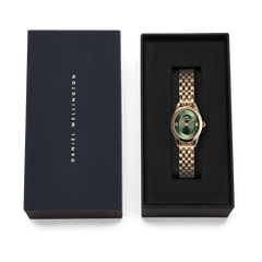 Ophelia Mini Emerald Gold watch with a gold beans link bracelet and emerald green sunray dial, presented in a black Daniel Wellington gift box.