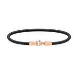 Slim men's bracelet featuring smooth black leather and a rose gold-plated stainless steel clasp, showcasing minimalist design and refined contrast.