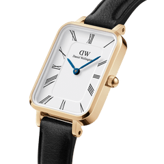 Quadro Roman Numerals Sheffield Gold ladies watch featuring a rectangular gold-plated case, minimalist white dial with Roman numerals, blue steel hands, and a slim black leather strap.