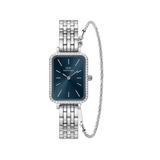 Rectangular ladies watch with a blue dial, crystal-studded bezel, and polished silver steel link strap, paired with a delicate twisted silver bracelet featuring subtle crystal accents.