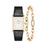 Rectangular gold watch with a white dial and black crocodile-embossed leather strap, paired with a gold chain-link bracelet featuring a pavé crystal accent and polished finish.