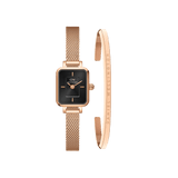 Quadro Mini Melrose Onyx set featuring a petite rose gold mesh strap watch with a rectangular black dial and a matching minimalist rose gold bracelet engraved with Daniel Wellington branding, ideal for women seeking a refined and versatile accessory.