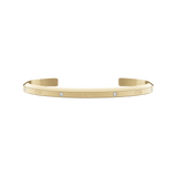 Slim gold cuff bracelet with a polished finish, featuring six sparkling crystals evenly spaced along the surface and an open design for comfortable wear.