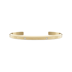 Slim gold cuff bracelet with a polished finish, featuring six sparkling crystals evenly spaced along the surface and an open design for comfortable wear.