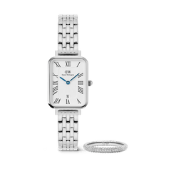 A rectangular Daniel Wellington Quadro 5-Link silver watch with a five-link stainless steel strap and Roman numeral dial, paired with a slim silver Pavé Ring featuring pavé crystal detailing, both displayed against a plain background.