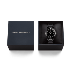 Iconic Paradigma Link Black men’s watch presented in a sleek black Daniel Wellington gift box, highlighting its polished link bracelet and minimalist black dial.