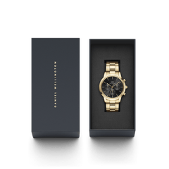 Iconic Chronograph Link Onyx G men's gold watch with a black sunray dial and chronograph features, elegantly presented in a Daniel Wellington gift box, ideal for special occasions.