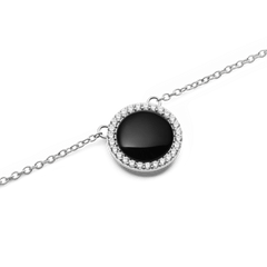 Close-up of the Audrey Necklace Black Agathe Silver, featuring a domed black agate pendant encircled by white cubic zirconia crystals on a polished silver chain.