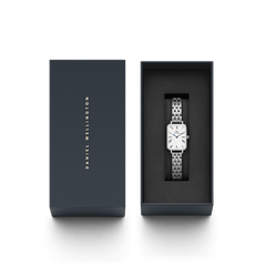 Quadro Roman Numerals 5-Link Silver watch presented in a sleek Daniel Wellington gift box, featuring a rectangular white dial with roman numerals, blue hands, and a polished five-link silver strap.