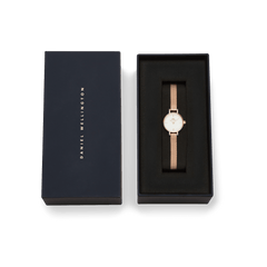 Petite Mini Melrose ladies watch with a rose gold mesh strap and minimalist white dial, elegantly presented in a branded Daniel Wellington gift box.