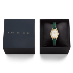 Daniel Wellington Ophelia Mini Green Lizard White Guilloché Gold watch displayed in its original black gift box, highlighting the green lizard-embossed leather strap and gold oval case.