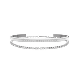 Classic & Tennis Bracelet Silver set featuring a polished minimalist silver cuff with engraved branding and a delicate tennis bracelet adorned with sparkling stones, both designed for elegant layering.